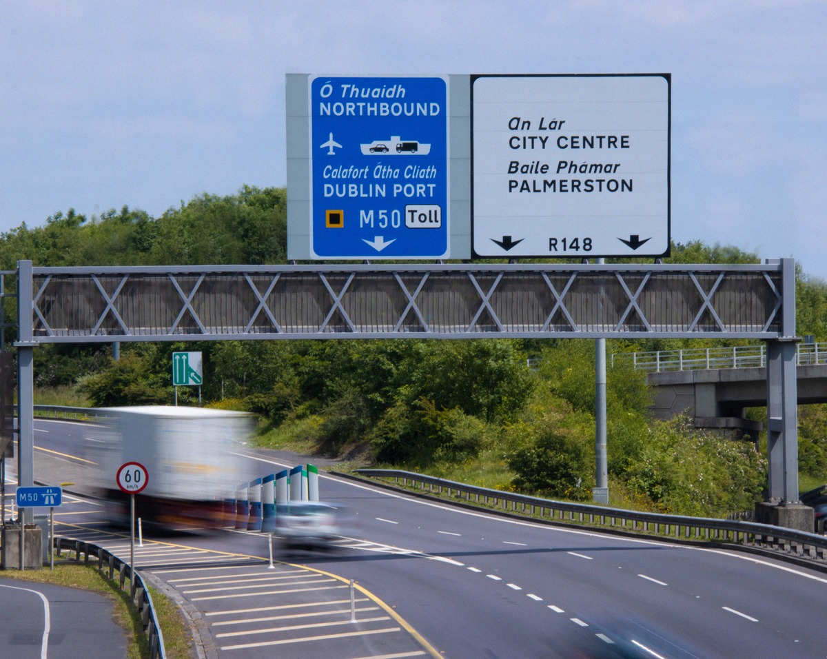 Signs on the M50 pointing to Dublin Port and the city centre.